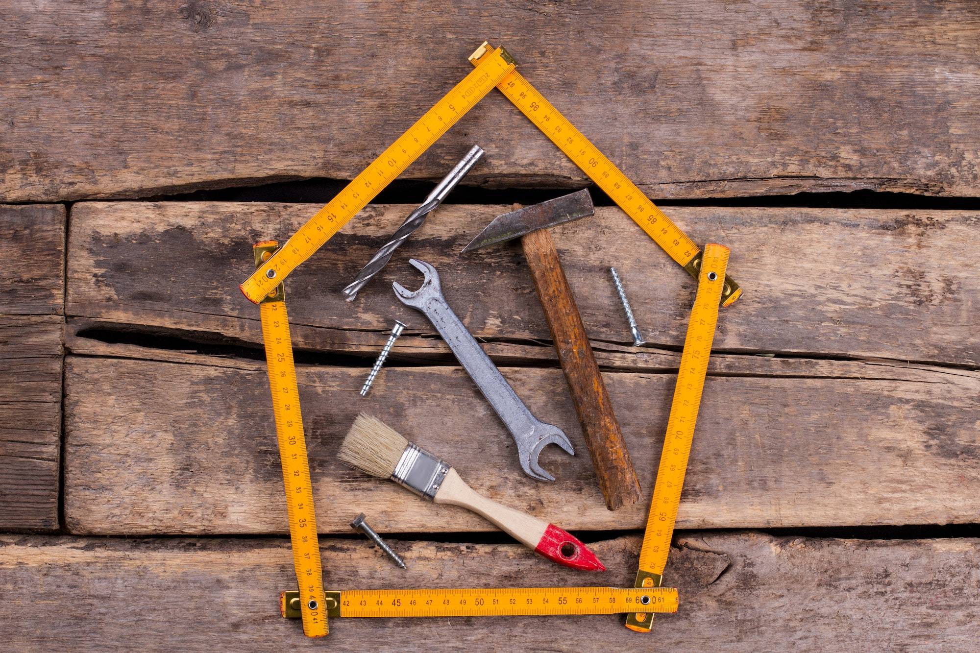 Different construction tools for construction on rustic background.